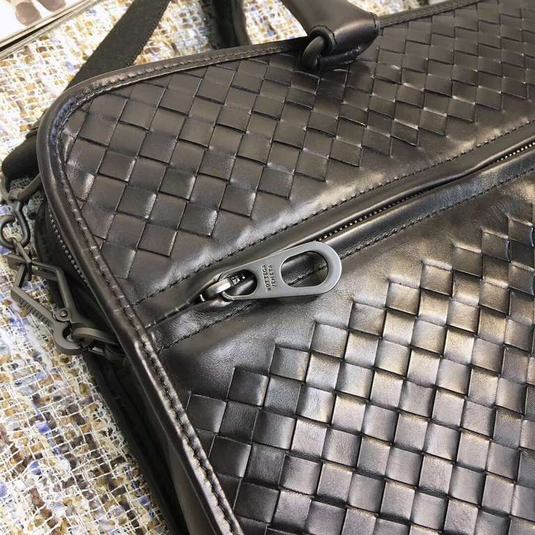 Briefcase   This practical briefcase is meticulously hand-woven and crafted from fetal cowhide leather for a lightweight look that easily organizes all of your daily essentials, from documents to a laptop. The design is 