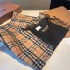 A warm and cozy scarf in soft cashmere. One side is adorned with a Burberry check pattern, while the other features a solid color design and the brand's logo. Produced in a 200-year-old specialist workshop in the Scottis