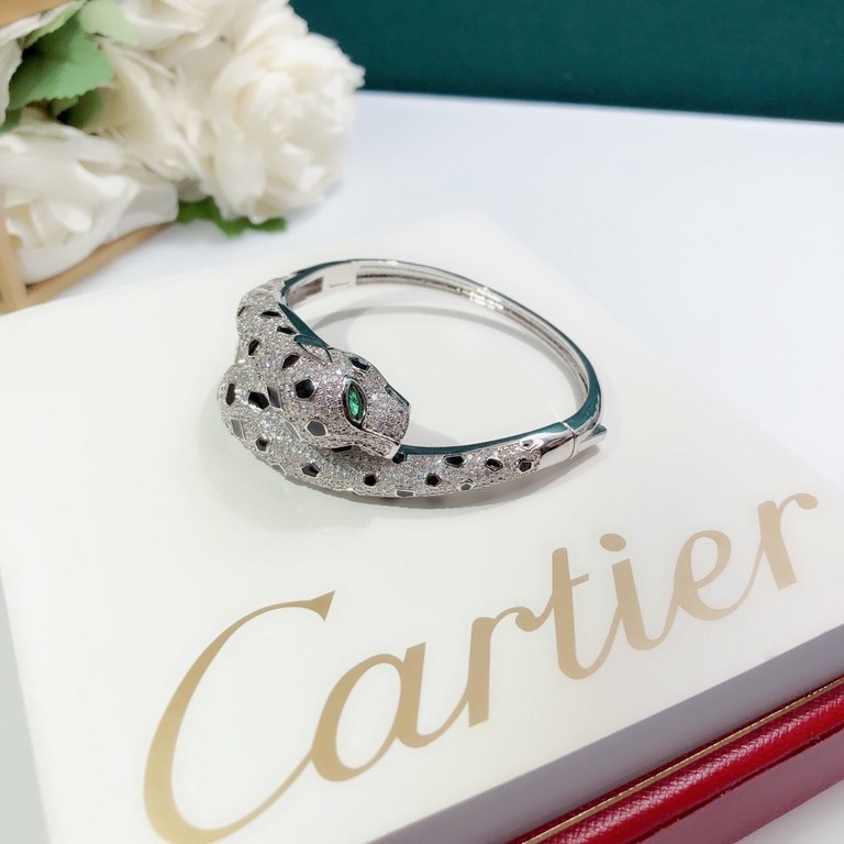 Dominant double panther head full diamond burst bracelet  Panthère de Cartier floral panther bracelet in 18K white gold    round brilliant diamonds. Emerald, the cheetah - as Cartier's iconic animal figure - first appear