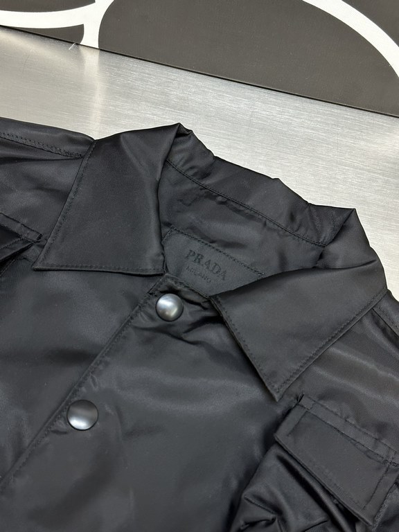 p415 Prada Prada Workwear Nylon JacketCrafted from iconic and innovative recycled nylon (Re-Nylon), it's finished with a bowling collar for a practical, modern look! Small, practical pockets add to the design, and the re