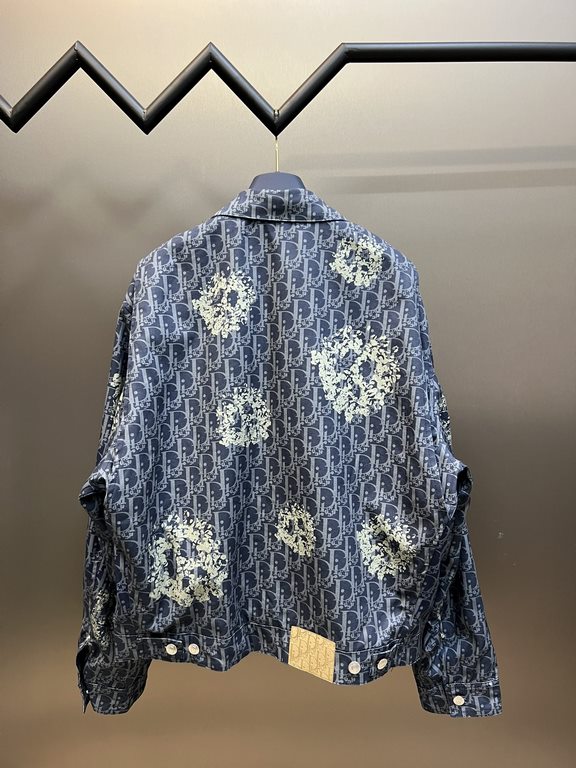 p495 Dior TEARS Floral Zip Jacket CoatExpertly crafted from cotton denim, it's decorated with a laser-drawn Oblique print layered with cotton-shaped detailing that showcases the co-branded collection's Peace Sign motif. 