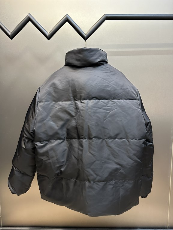 p675 PRADA Prada Reversible Down JacketPrada's iconic triangle logo is reinterpreted as a quilted pattern on this Re-Nylon stand-up jacket. The body has a modern, streetwear-inspired appeal, with an enameled metal triang