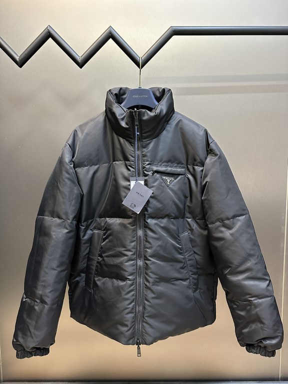 p675 PRADA Prada Reversible Down JacketPrada's iconic triangle logo is reinterpreted as a quilted pattern on this Re-Nylon stand-up jacket. The body has a modern, streetwear-inspired appeal, with an enameled metal triang