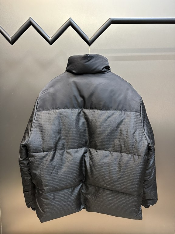 p675 PRADA Prada Reversible Down JacketPrada's iconic triangle logo is reinterpreted as a quilted pattern on this Re-Nylon stand-up jacket. The body has a modern, streetwear-inspired appeal, with an enameled metal triang