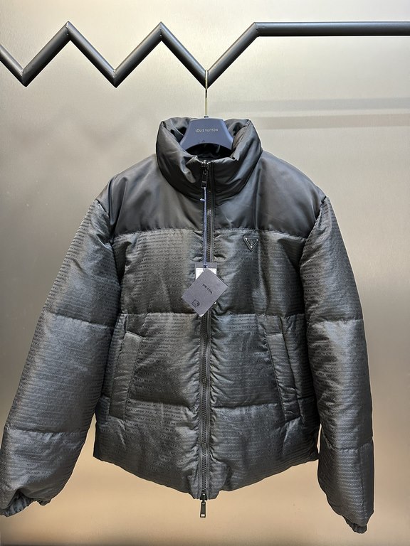 p675 PRADA Prada Reversible Down JacketPrada's iconic triangle logo is reinterpreted as a quilted pattern on this Re-Nylon stand-up jacket. The body has a modern, streetwear-inspired appeal, with an enameled metal triang