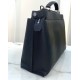 Minimalist design model lightweight handbag with two compartments separated by a rigid panel. Briefcase handles with adjustable, removable shoulder strap. Features interior patch pocket and signature twist lock. In black