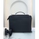 Minimalist design model lightweight handbag with two compartments separated by a rigid panel. Briefcase handles with adjustable, removable shoulder strap. Features interior patch pocket and signature twist lock. In black