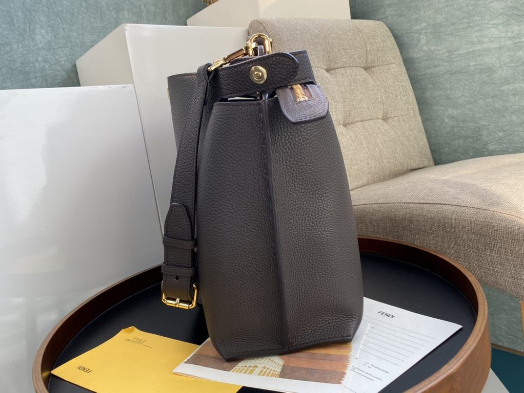 Minimalist design model lightweight handbag with two compartments separated by a rigid panel. Briefcase handles with adjustable, removable shoulder strap. Features interior patch pocket and signature twist lock. In dark 