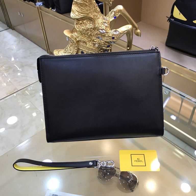 Fendi Fendi Original New Clutch Sharply designed zipper clutch. Made of black Romano leather. Contrasting Fendi lettering patch printed on the bottom side of the Romano leather. Palladium-finish metalwork.Size 27-20-6Mod