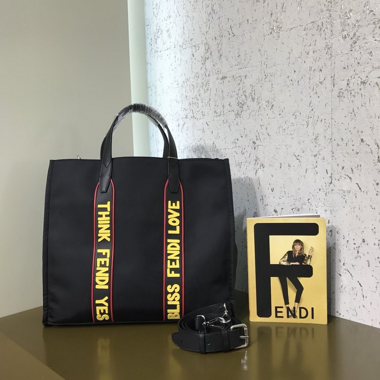 F Home Black nylon and leather tote bag with adjustable shoulder strap and double handles wrapped around the bag in black, red and yellow rubber appliqués inspired by the theme F VOCABULARY, zippered inside pocket.391935