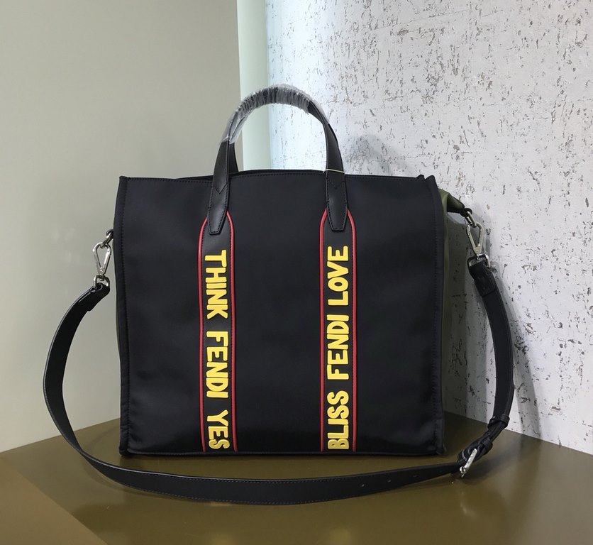 F Home Black nylon and leather tote bag with adjustable shoulder strap and double handles wrapped around the bag in black, red and yellow rubber appliqués inspired by the theme F VOCABULARY, zippered inside pocket.391935