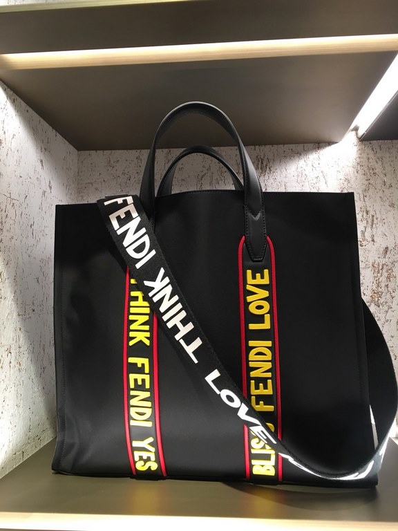 F Home Black nylon and leather tote bag with adjustable shoulder strap and double handles wrapped around the bag in black, red and yellow rubber appliqués inspired by the theme F VOCABULARY, zippered inside pocket.391935