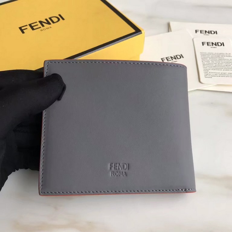 F family folding wallet in gray calfskin with appliquéd speechless emoji, lined with eight card slots and two cash compartments.