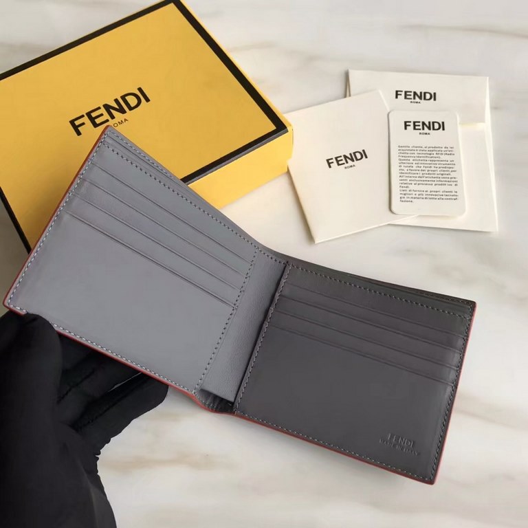 F family folding wallet in gray calfskin with appliquéd speechless emoji, lined with eight card slots and two cash compartments.