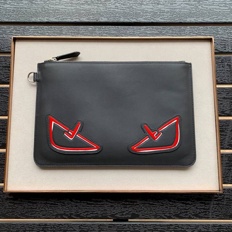 F family clutch bag in thin calfskin leather, embossed with a color-printed eye shape, zipper closure and engraved with the F logo on the back. 30.20cm