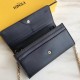 Long wallet in calfskin leather decorated with conical rivets and metal rings, with 2 crotch-access compartments, 1 zipper pocket, 10 card slots and side-opening pockets, and detachable chain shoulder strap.19cm (boxed g