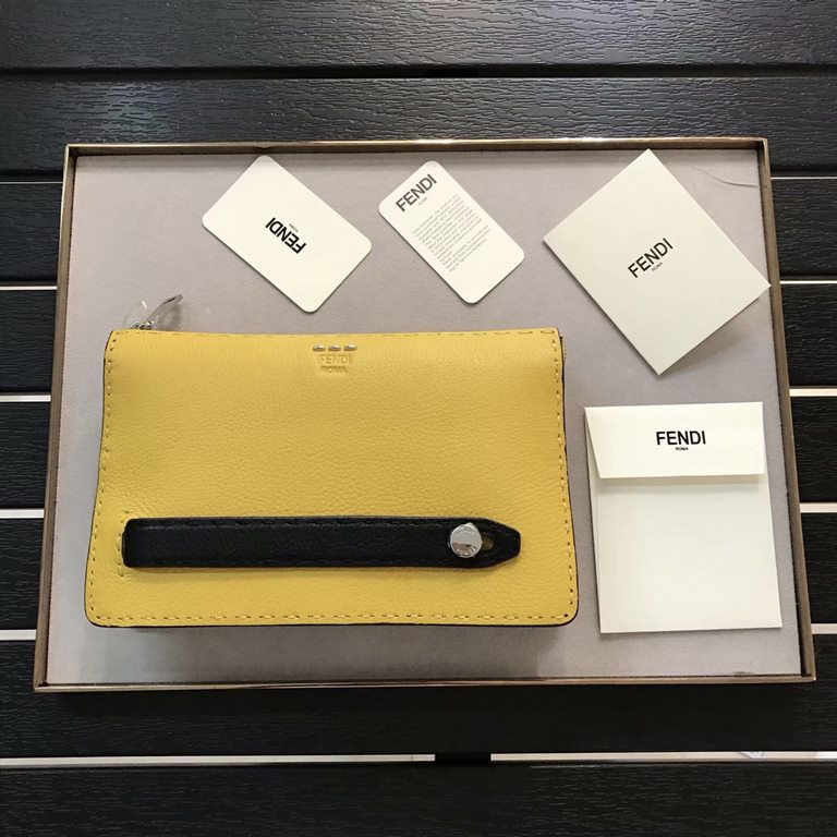 F Lychee leather clutch bag with raw feel cut edges, hand-stitching, black piping, color-blocked sides, lined interior, featuring 8 card compartments and 1 wide crotch-accessible pocket. 24cm.