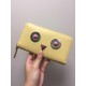 Family F Wheat yellow calf leather [rose][rose] zippered long wallet, [strong][strong] decorated with metal appliqués and multicolored plexiglass rivets forming a decorative pattern of rounded eyes, with a crotch catchin