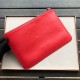 F family clutch bag in red calf leather, decorated with a metal appliqué with a speechless expression and the F ROMA logo on the back. 30cm.