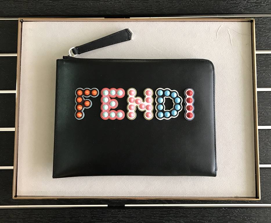 F Family Black Calfskin clutch bag with F-shaped decorative detailing consisting of studs in the center and a top zipper 26cm.