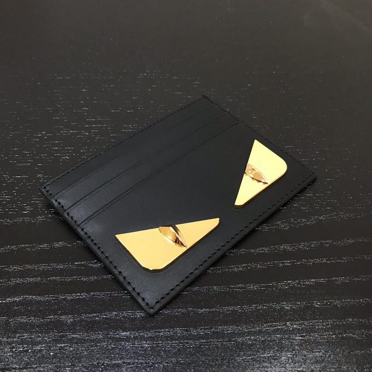 FEND1 CRAYONS card holder with center compartment and six credit card holders. Embellished with the FENDI ROMA logo and an interior plaque. Made of black calf leather with BAG BUGS eye graphic made of metal appliqués on 