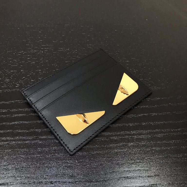 FEND1 CRAYONS card holder with center compartment and six credit card holders. Embellished with the FENDI ROMA logo and an interior plaque. Made of black calf leather with BAG BUGS eye graphic made of metal appliqués on 