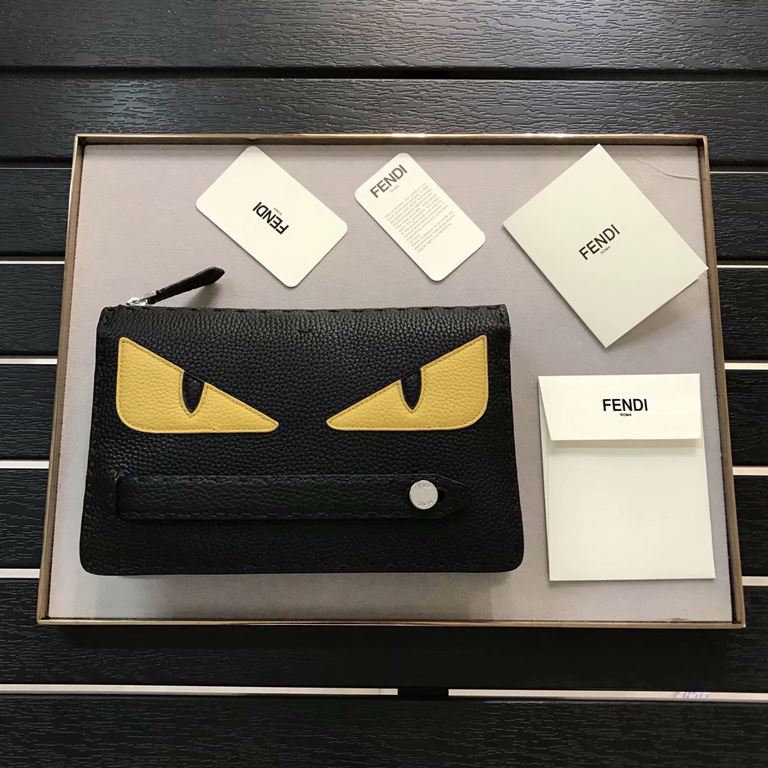 F family black lychee leather clutch bag with yellow leather BAG BUGS eye pattern inlaid trim, tote strap and zipper closure, three interior compartments with eight card slots, a wide crotch catching billfold, organizer 