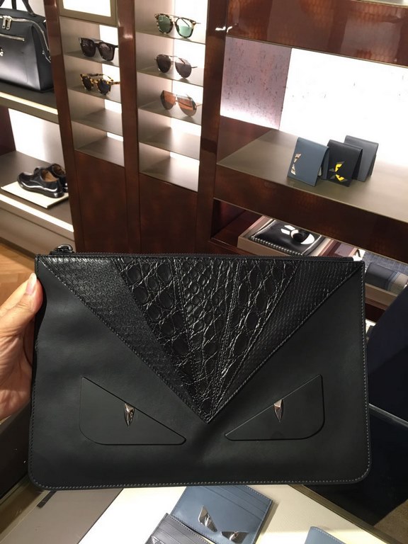 Slim black calf leather clutch bag from F featuring a BAG BUGS eye motif in matching crocodile and brocade snakeskin inlays and black satin metal details, zipper closure and F logo embellishment on the back. 30cm.