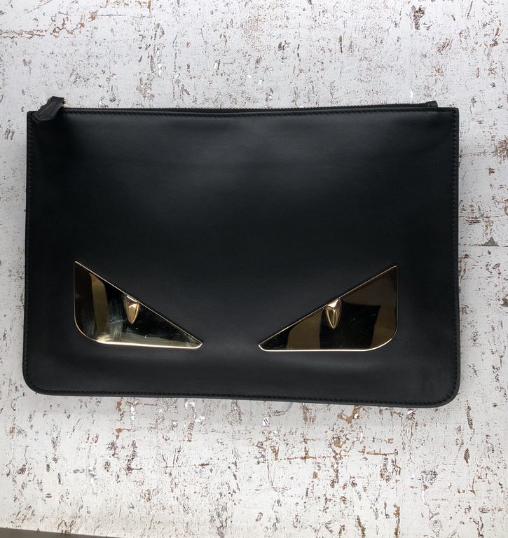 Clutch bag in calf leather, decorated with a BAG BUGS eye shape made of metal appliqués and a logo on the back. 30 cm.