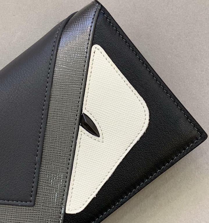 F Family Gun Graphite black and gray calf leather long wallet with color-blocked inserts presenting BAG BUGS eye pattern styling, leather lining, 13 card compartments, 1 large crotch-accessible compartment, flat flap poc