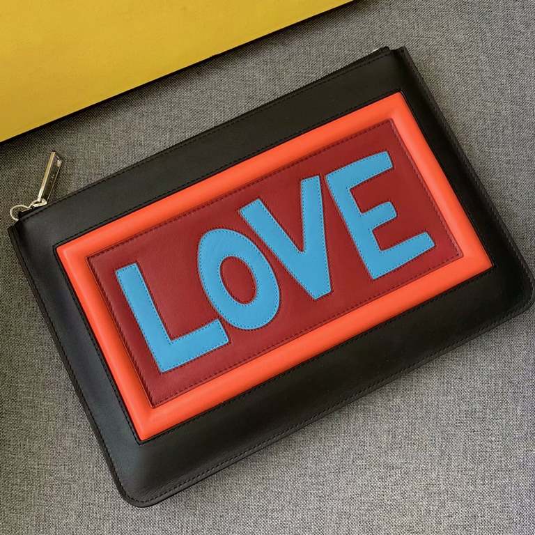 F family thin black calf leather clutch. FE and LOVE lettering on the back with appliqués inspired by the F VOCABULARY theme and multicolored rubber details. Zipper closure and palladium-finish metal hardware. 30cm.