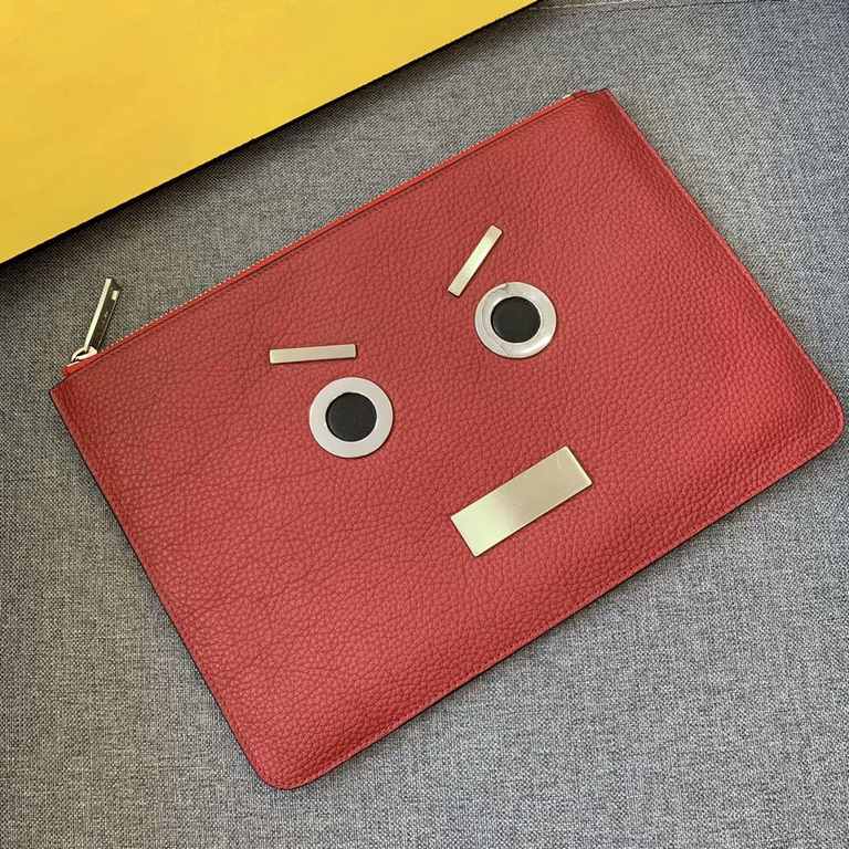 F family Litchi print Roman slim clutch bag with metal appliqués featuring the speechless expression inspired by FACES, zipper closure and microfiber lining. 30cm.