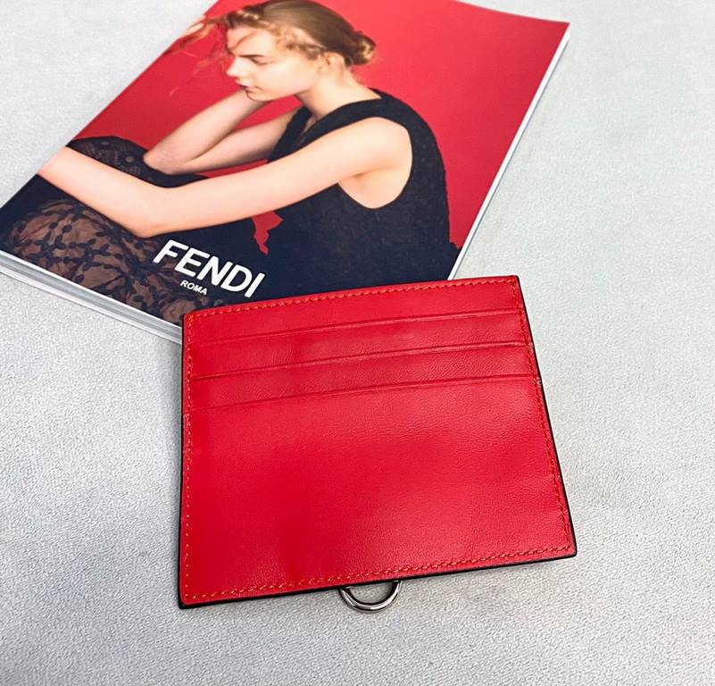 Flat card holder in Fendi calf leather, with metal rings and chic conical rivets that allow the holder to be fastened to a handbag or attached to a small charm, central compartment and 6 card slots. （Center compartment a