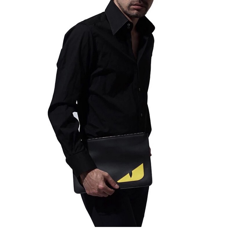 Thin black calf leather clutch bag decorated with black and yellow Bag Bugs eye shape embossed inlays. Zipper closure. F logo adorns the back. Made in Italy Size 29x19x1cm