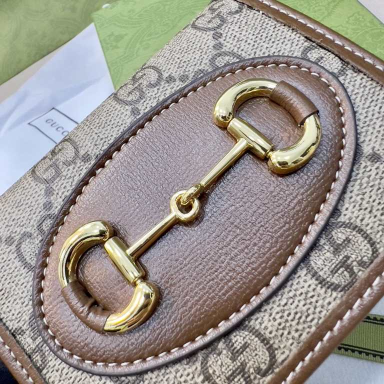 New to the      SpringSummer collection is the Gucci    1955 Horsebit Card Case in GG Supreme premium faux canvas and brown leather. This detail is inspired by the brand's equestrian roots and is part of Gucci's classic 