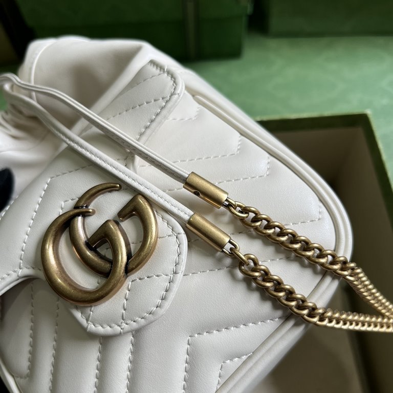 .   Comes with a full set of original green box packaging  GG Marmont Collection Mini Bucket Bag. This mini bucket bag is crafted in white quilted V-shaped leather. A signature element of the GG Marmont collection, the g