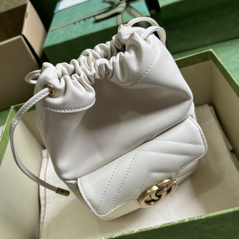 .   Comes with a full set of original green box packaging  GG Marmont Collection Mini Bucket Bag. This mini bucket bag is crafted in white quilted V-shaped leather. A signature element of the GG Marmont collection, the g