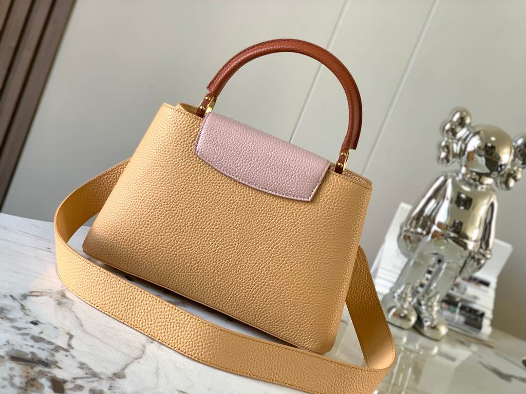 M59466 apricot yellow with light earthy gold clasp]A modern clash of shades in full-grain cowhide leather, this medium Capucines bag features the iconic LV alphabet and side loops, top handles and a detachable shoulder s