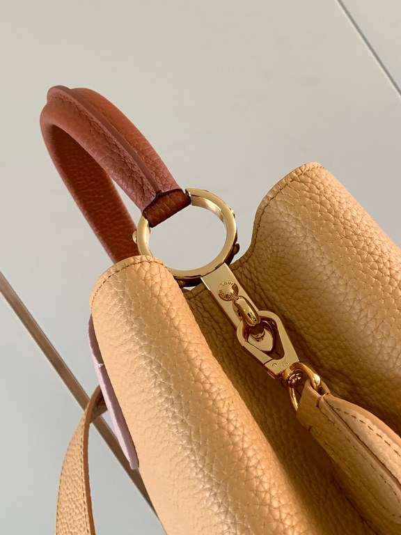 M59466 apricot yellow with light earthy gold clasp]A modern clash of shades in full-grain cowhide leather, this medium Capucines bag features the iconic LV alphabet and side loops, top handles and a detachable shoulder s