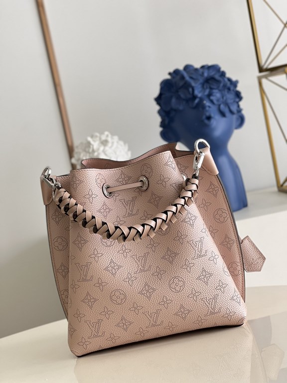 ExclusiveM58788 Pearlescent Pink] The Muria Bucket Bag is crafted from cutout cowhide leather that lends a metallic sheen to the perforated Monogram pattern, and is finished with a leather name tag and key holder. Explor