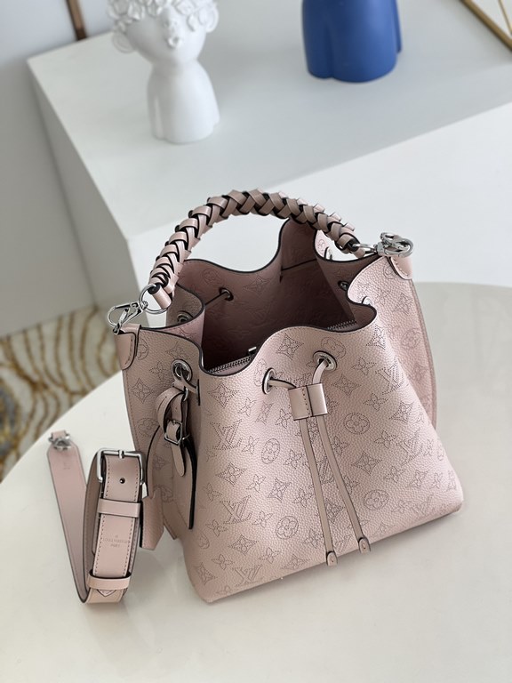 ExclusiveM58788 Pearlescent Pink] The Muria Bucket Bag is crafted from cutout cowhide leather that lends a metallic sheen to the perforated Monogram pattern, and is finished with a leather name tag and key holder. Explor