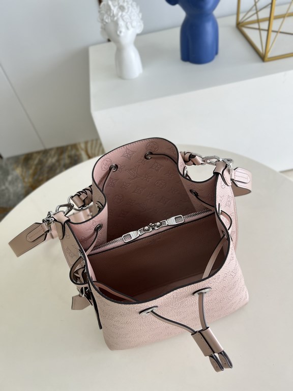 ExclusiveM58788 Pearlescent Pink] The Muria Bucket Bag is crafted from cutout cowhide leather that lends a metallic sheen to the perforated Monogram pattern, and is finished with a leather name tag and key holder. Explor