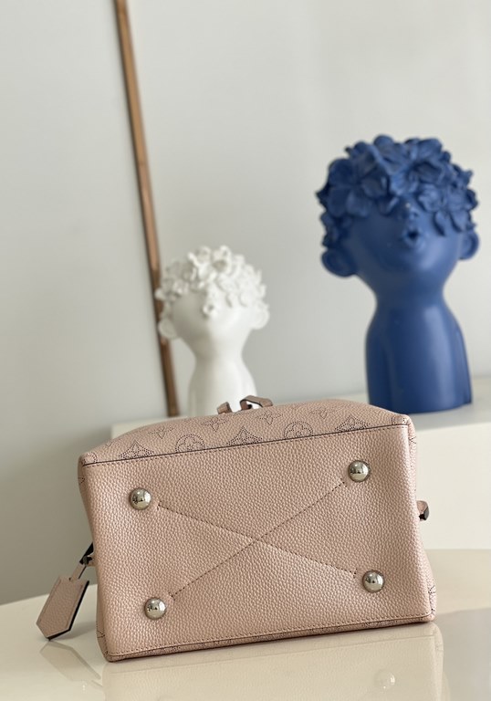 ExclusiveM58788 Pearlescent Pink] The Muria Bucket Bag is crafted from cutout cowhide leather that lends a metallic sheen to the perforated Monogram pattern, and is finished with a leather name tag and key holder. Explor