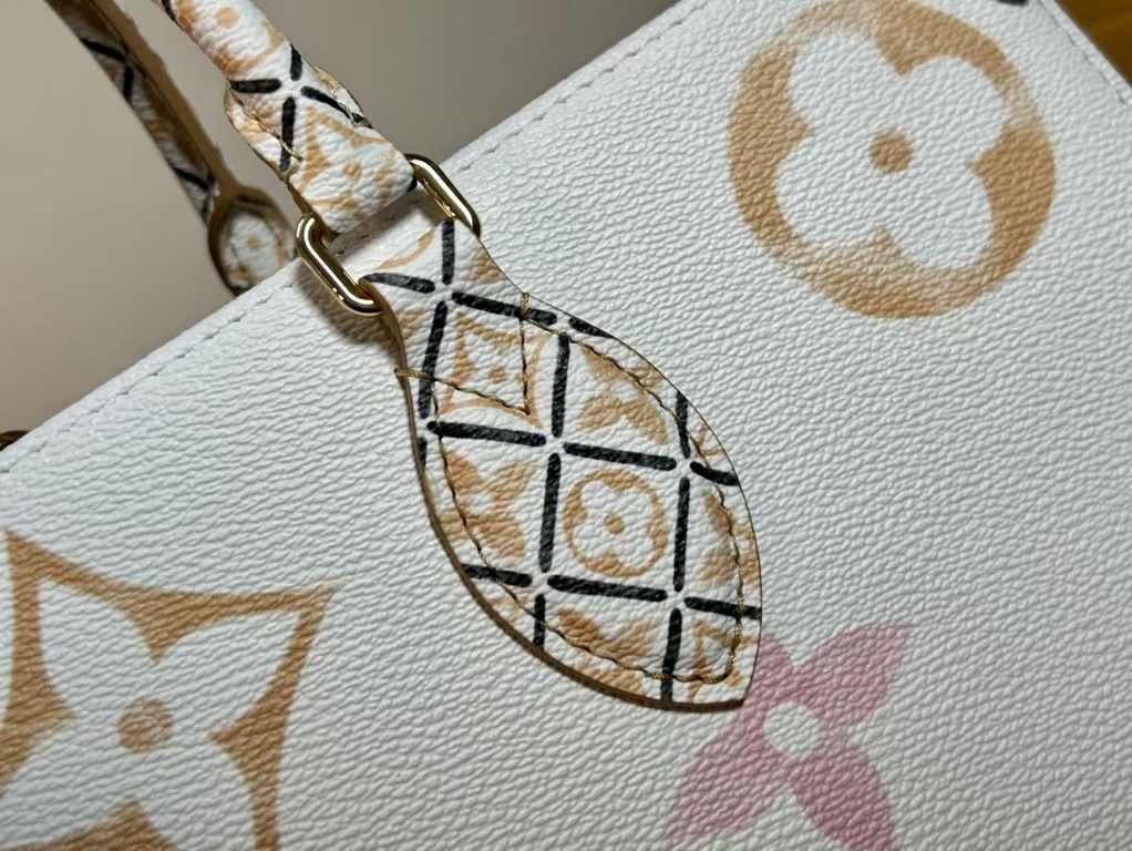 M22975 Apricot, this medium OnTheGo bag is made of coated canvas depicting a large Monogram pattern, then trimmed and lined with intricate Monogram florals inspired by traditional Portuguese flower tiles. The roomy desig