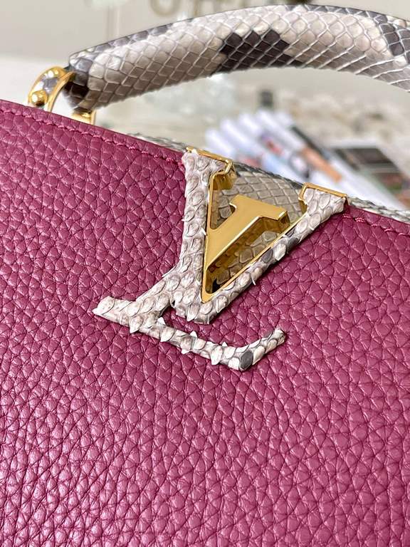 PremiumN82067 Grape Purple with Parisian Pink Python and Gold BucklesIn grained Taurillon leather with python flap, top handle and LV monogram, this Capucines mini bag has a luxurious feel. The contrasting light-colored 