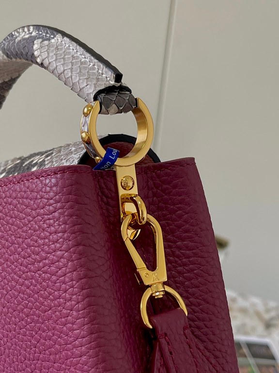 PremiumN82067 Grape Purple with Parisian Pink Python and Gold BucklesIn grained Taurillon leather with python flap, top handle and LV monogram, this Capucines mini bag has a luxurious feel. The contrasting light-colored 