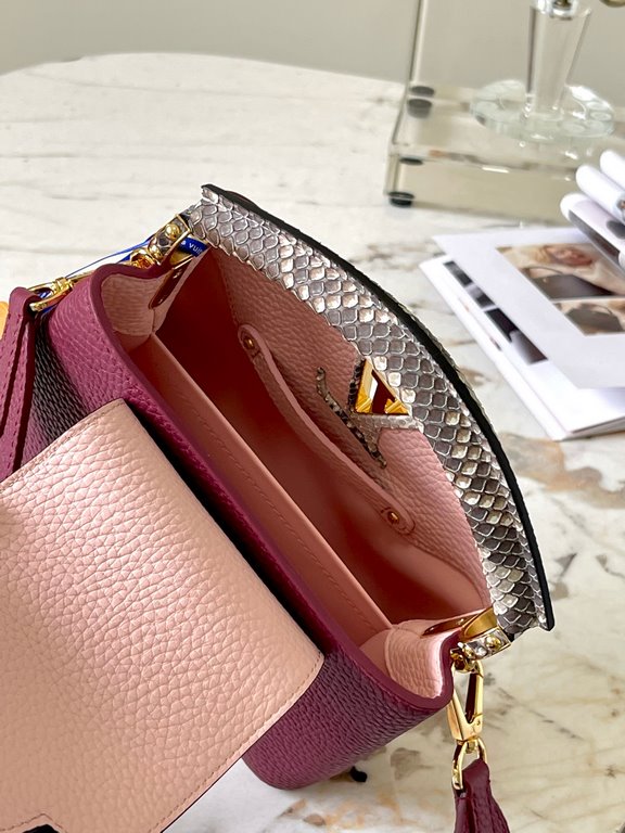 PremiumN82067 Grape Purple with Parisian Pink Python and Gold BucklesIn grained Taurillon leather with python flap, top handle and LV monogram, this Capucines mini bag has a luxurious feel. The contrasting light-colored 