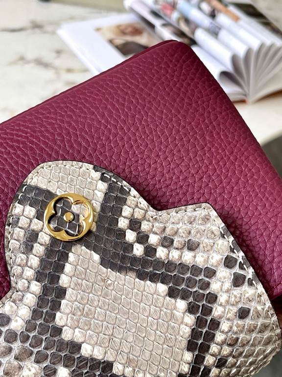 PremiumN82067 Grape Purple with Parisian Pink Python and Gold BucklesIn grained Taurillon leather with python flap, top handle and LV monogram, this Capucines mini bag has a luxurious feel. The contrasting light-colored 