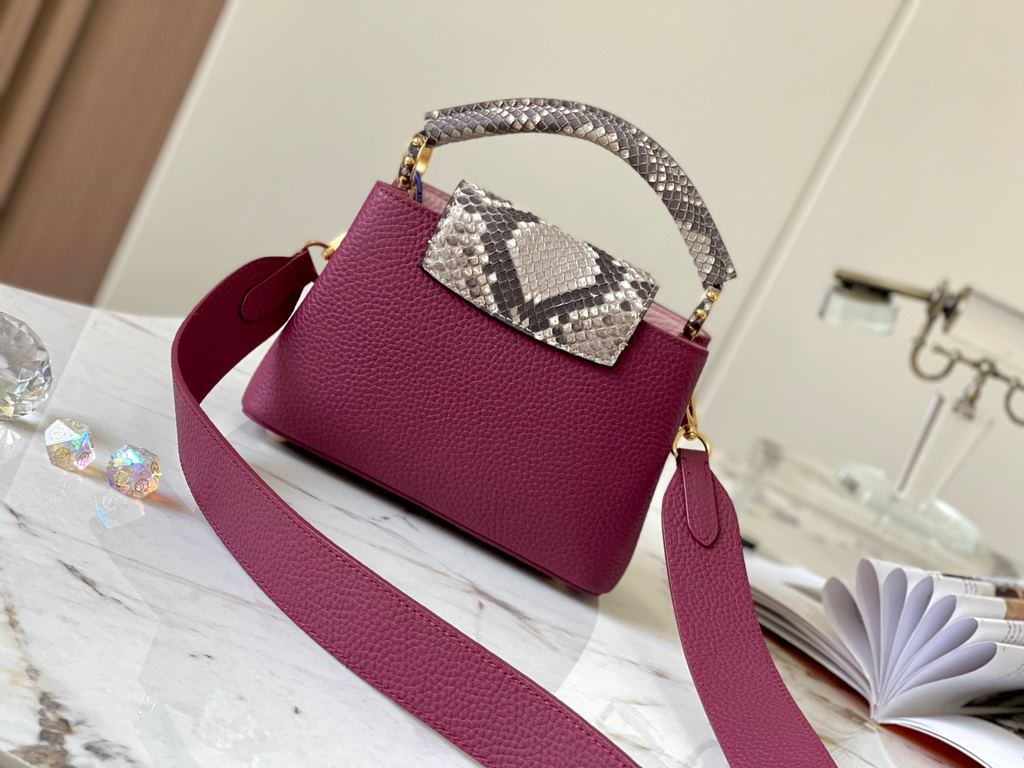 PremiumN82067 Grape Purple with Parisian Pink Python and Gold BucklesIn grained Taurillon leather with python flap, top handle and LV monogram, this Capucines mini bag has a luxurious feel. The contrasting light-colored 