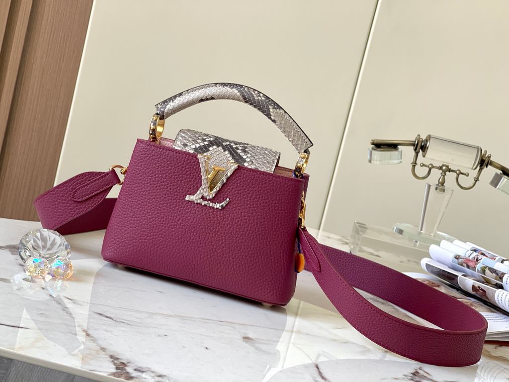 PremiumN82067 Grape Purple with Parisian Pink Python and Gold BucklesIn grained Taurillon leather with python flap, top handle and LV monogram, this Capucines mini bag has a luxurious feel. The contrasting light-colored 